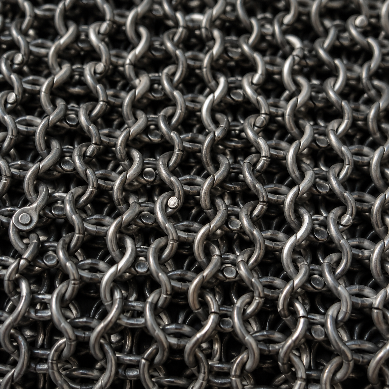Close detail of riveted interlinked steel mail rings